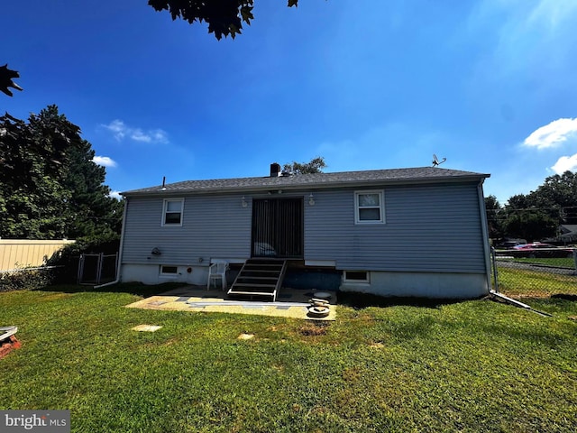 rear view of house featuring a yard