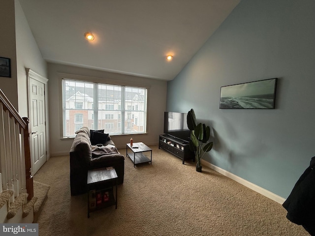 sitting room with vaulted ceiling and carpet