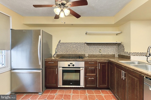 kitchen featuring appliances with stainless steel finishes, decorative backsplash, sink, ceiling fan, and dark brown cabinets