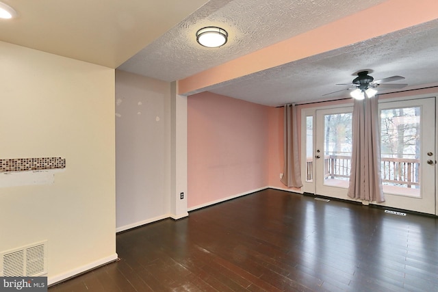 spare room featuring ceiling fan, a textured ceiling, and dark hardwood / wood-style flooring