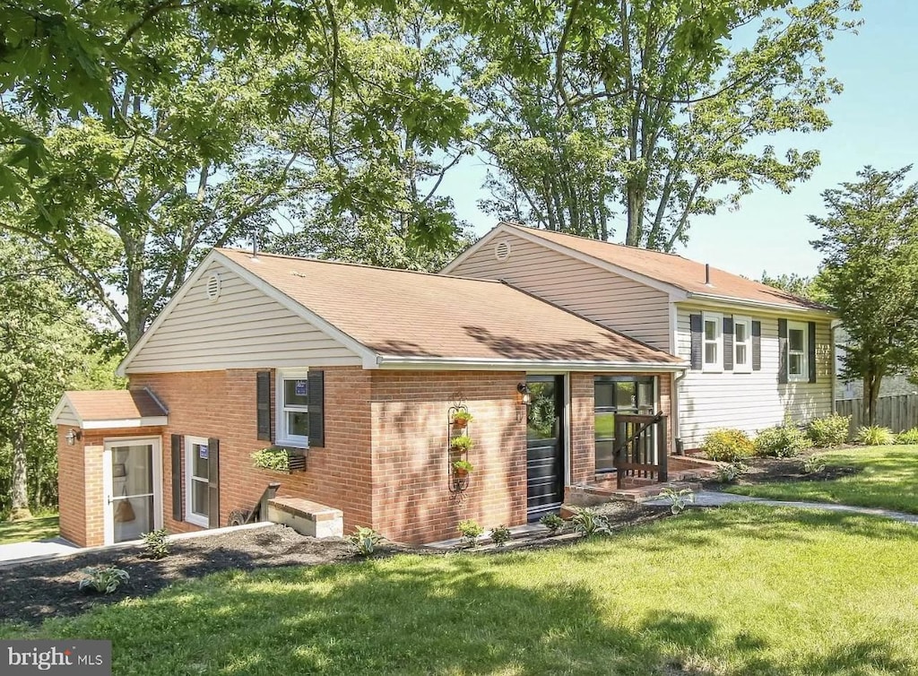 rear view of house with a yard