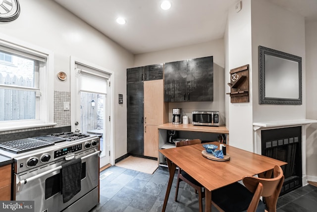 kitchen featuring stainless steel appliances and tasteful backsplash