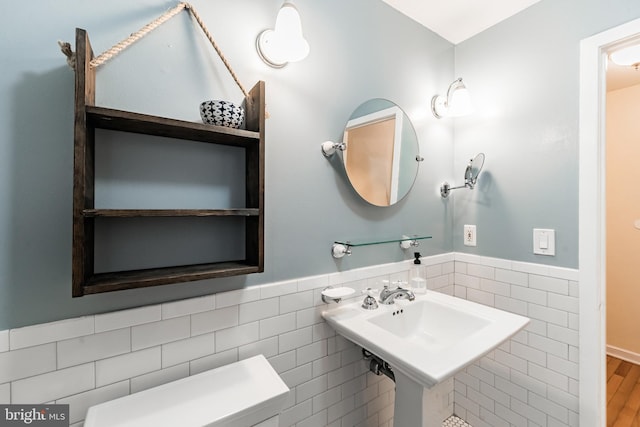 bathroom with tile walls and sink