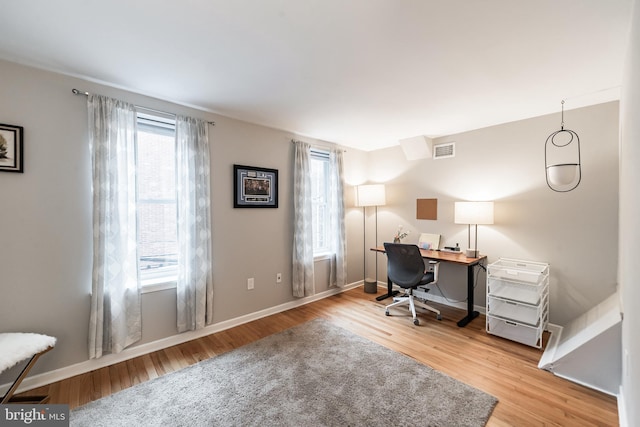 office space with light hardwood / wood-style floors