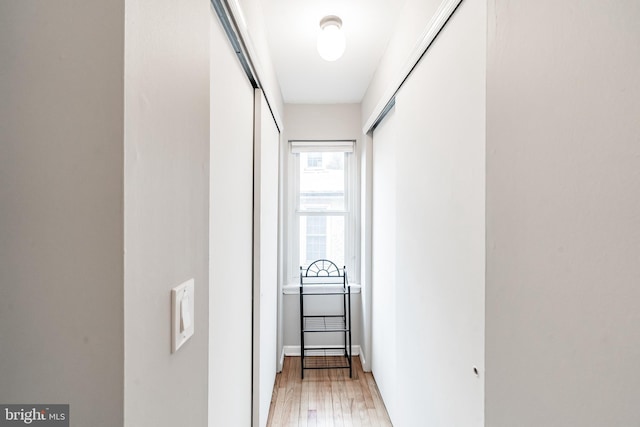 corridor with light hardwood / wood-style flooring