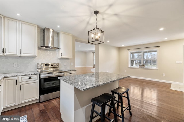 kitchen with backsplash, baseboards, wall chimney range hood, dark wood finished floors, and electric range