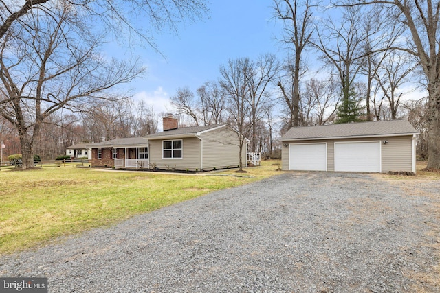 view of home's exterior with an outbuilding, a lawn, a garage, and a chimney