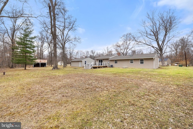 view of yard with a carport and a wooden deck