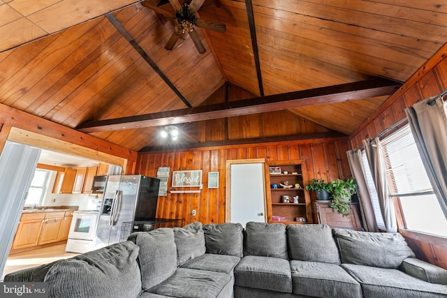 living room featuring wooden walls, a wealth of natural light, and wooden ceiling