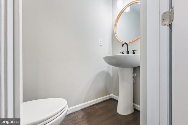 bathroom with toilet and hardwood / wood-style flooring