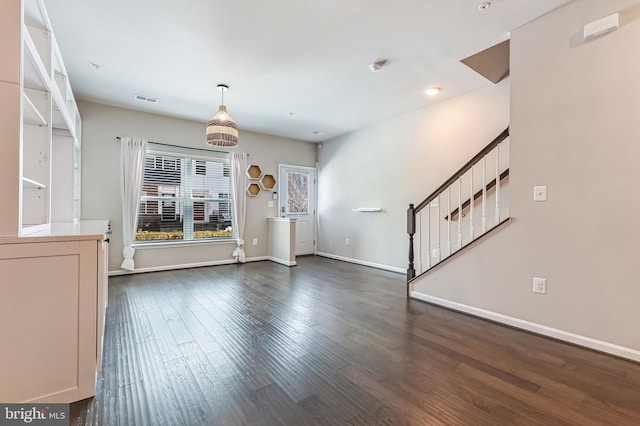 unfurnished living room with dark hardwood / wood-style flooring