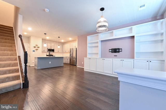 unfurnished living room featuring dark hardwood / wood-style flooring