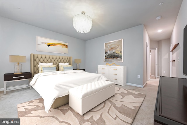 bedroom with light colored carpet and a notable chandelier