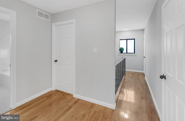 corridor with light wood-type flooring