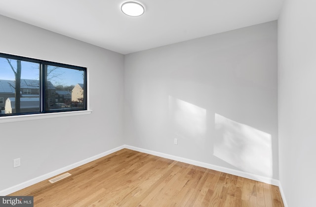 empty room with hardwood / wood-style floors