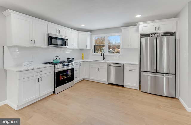 kitchen featuring white cabinetry, appliances with stainless steel finishes, and light hardwood / wood-style flooring