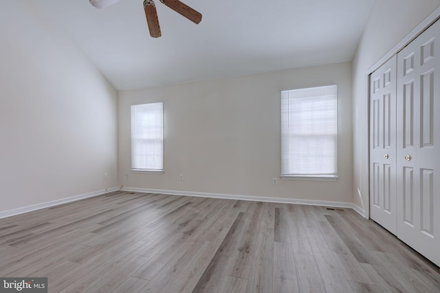 unfurnished bedroom featuring ceiling fan, light hardwood / wood-style floors, and multiple windows