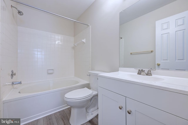 full bathroom with toilet, hardwood / wood-style floors, shower / washtub combination, and vanity