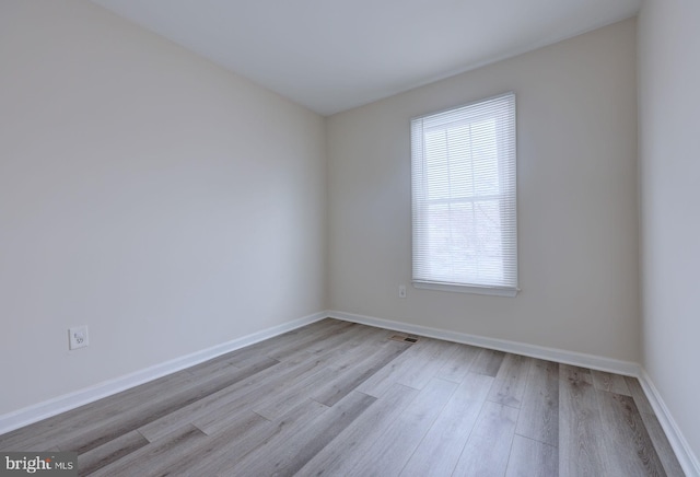 empty room with light hardwood / wood-style flooring