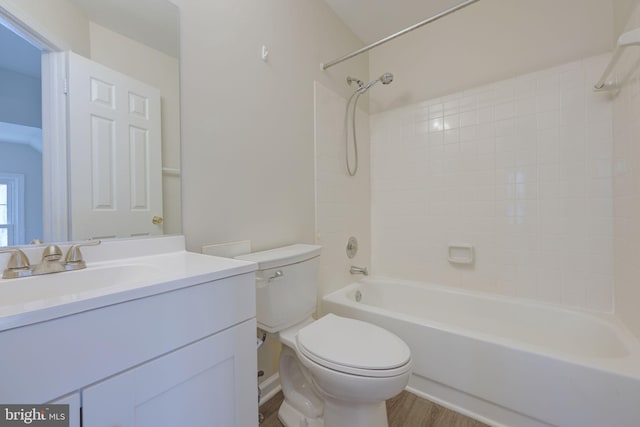 full bathroom featuring tub / shower combination, hardwood / wood-style floors, toilet, and vanity