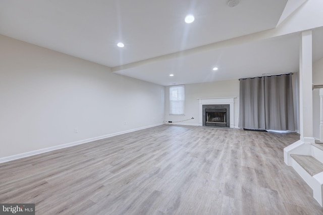 unfurnished living room with light hardwood / wood-style flooring