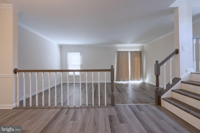 stairs featuring hardwood / wood-style flooring and crown molding