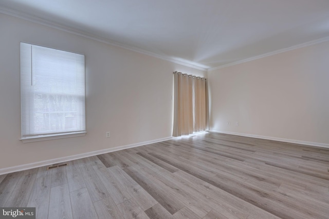 unfurnished room featuring crown molding and light hardwood / wood-style floors