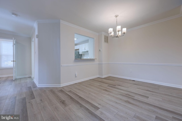 interior space with crown molding, light hardwood / wood-style flooring, and a notable chandelier