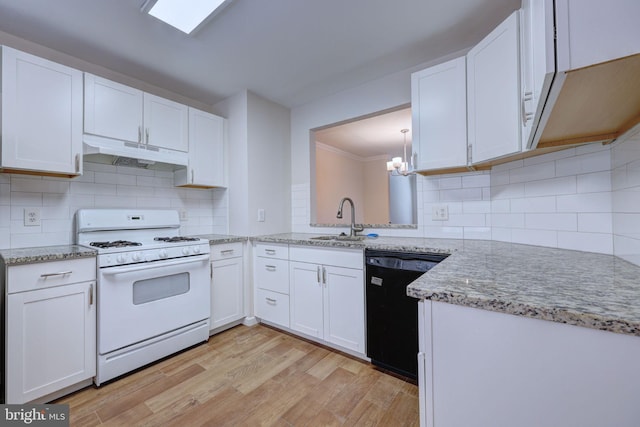 kitchen featuring tasteful backsplash, gas range gas stove, sink, black dishwasher, and white cabinets