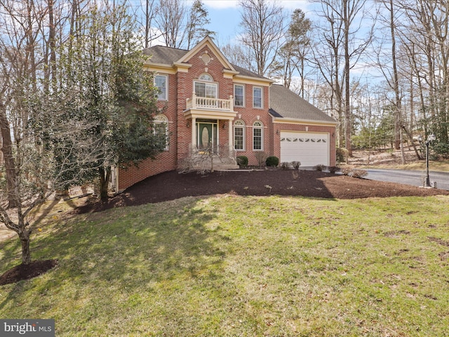 colonial home featuring a front lawn, a balcony, an attached garage, and brick siding