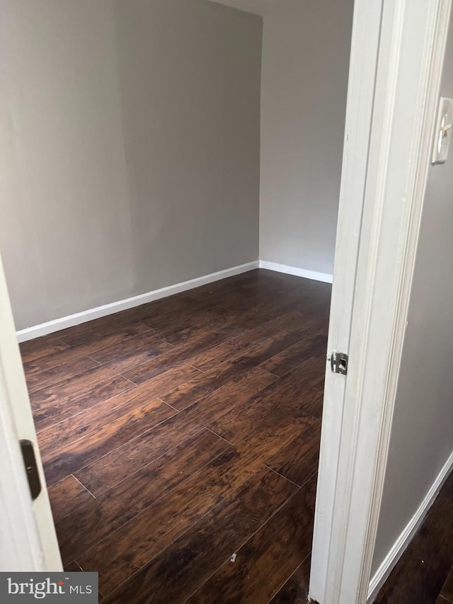 spare room featuring dark hardwood / wood-style floors