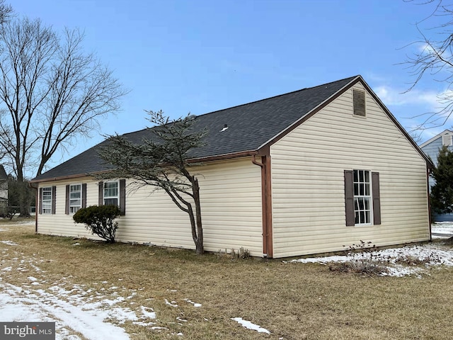 view of snow covered exterior featuring a lawn