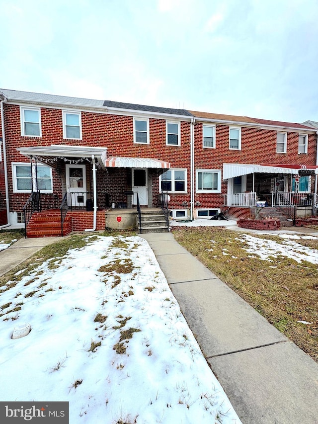 multi unit property with a porch and a yard