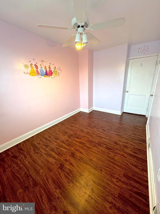 unfurnished room with ceiling fan and dark hardwood / wood-style floors