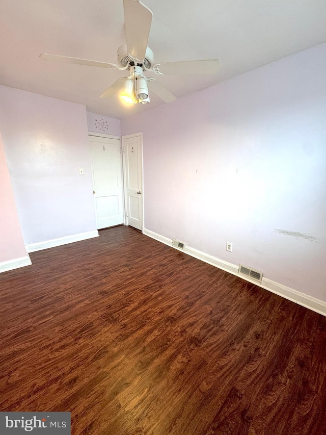 unfurnished room with ceiling fan and dark hardwood / wood-style flooring