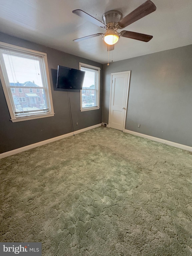 unfurnished bedroom with ceiling fan and carpet floors