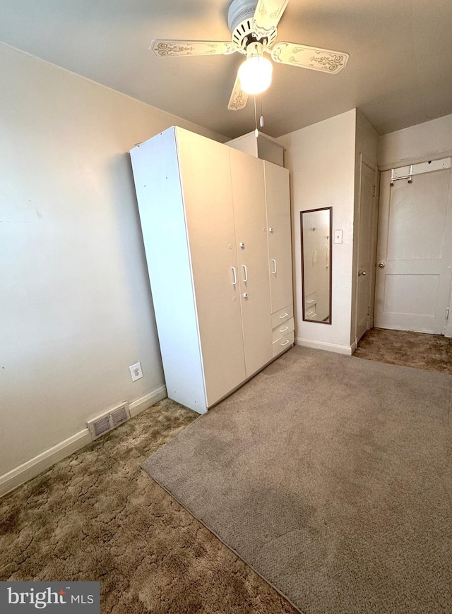 unfurnished bedroom with carpet flooring and ceiling fan