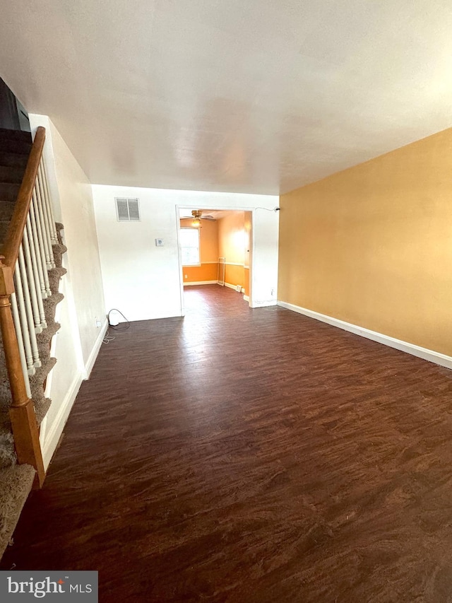 unfurnished living room with ceiling fan and dark hardwood / wood-style flooring