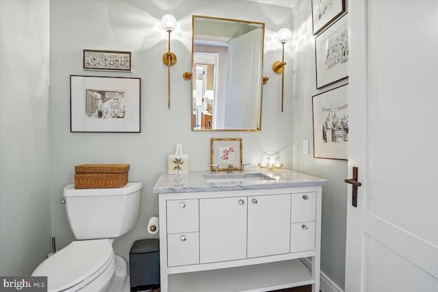 bathroom featuring toilet and vanity