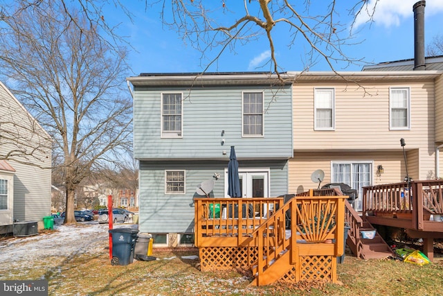 back of house featuring a wooden deck and central air condition unit