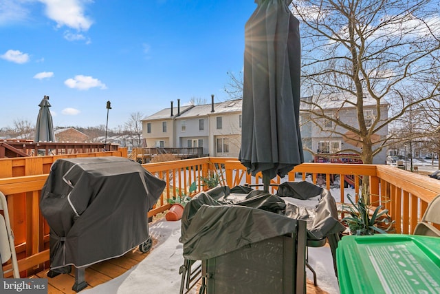 wooden terrace featuring a grill