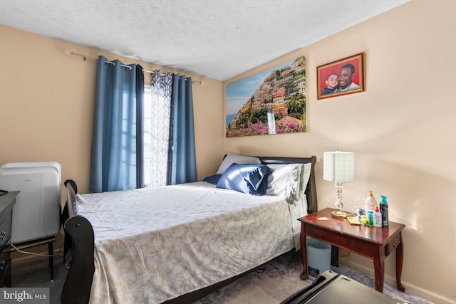 bedroom featuring carpet floors and a textured ceiling