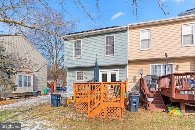 rear view of property with french doors and a deck