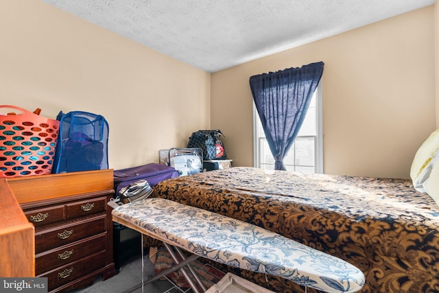 bedroom featuring carpet and a textured ceiling