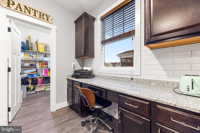 office with hardwood / wood-style floors and built in desk