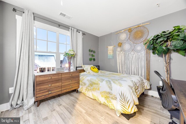 bedroom with light hardwood / wood-style floors