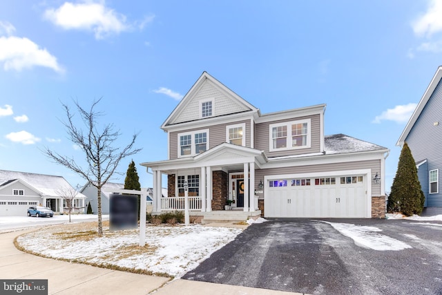 view of front of property with covered porch and a garage