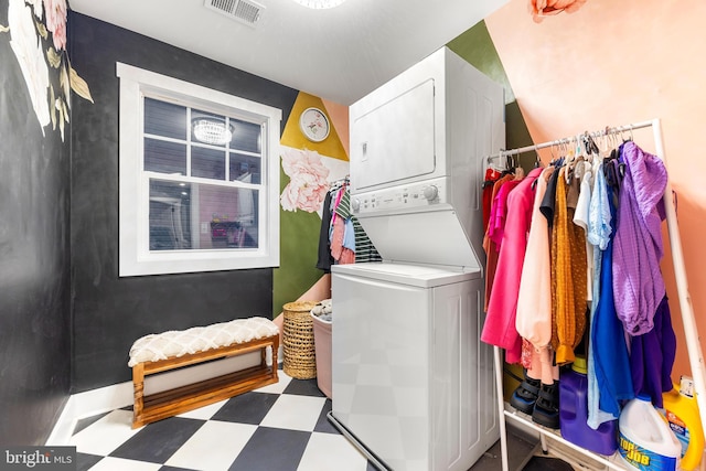 laundry area with stacked washing maching and dryer