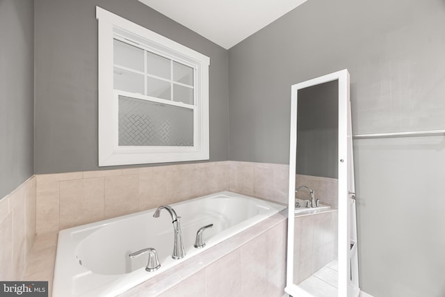 bathroom featuring a relaxing tiled tub