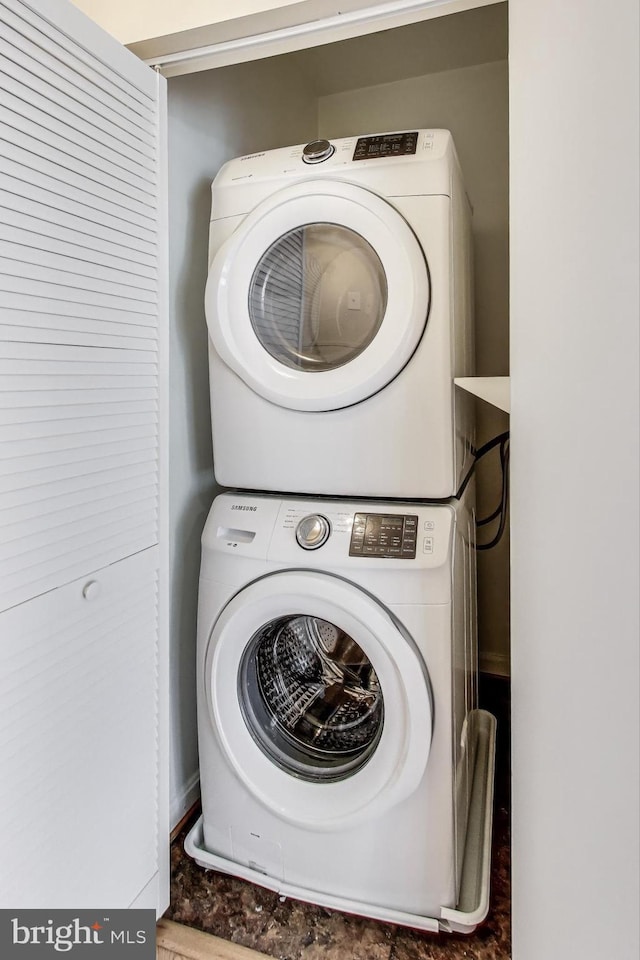 washroom featuring stacked washer and dryer